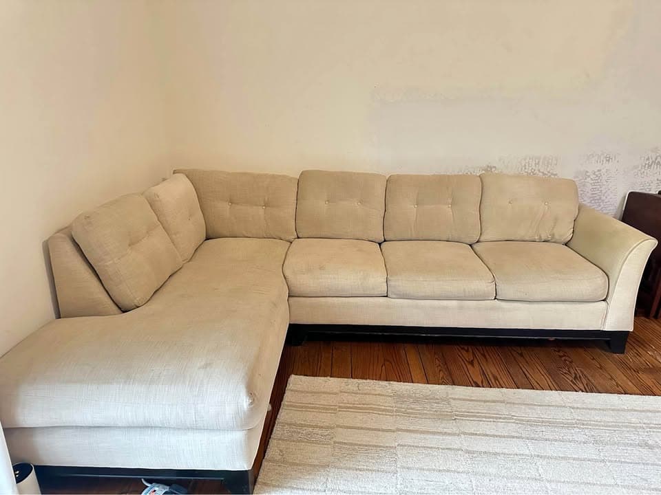 Original room photo of a light-colored sectional sofa